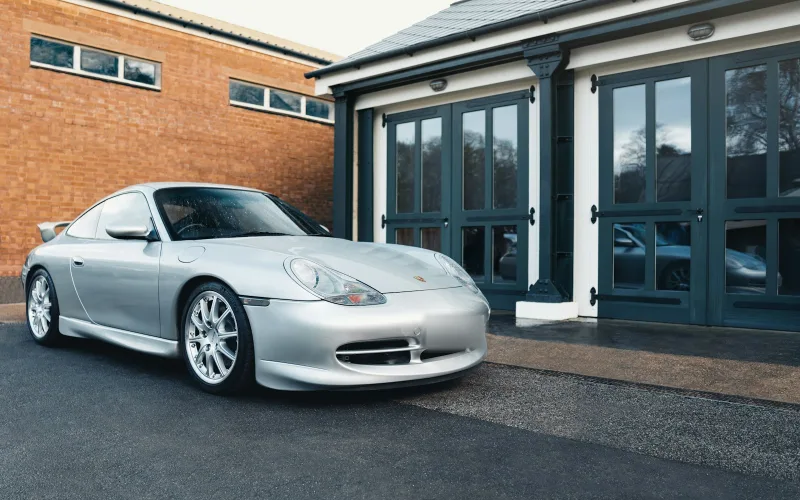 Silver 996 GT3 outside a garage at Bicester Heritage